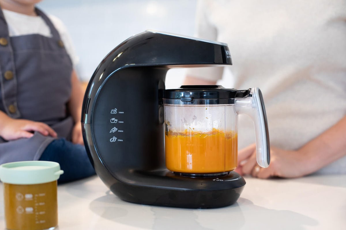 Compact size KiddoKook Pro baby food maker sitting on a kitchen counter