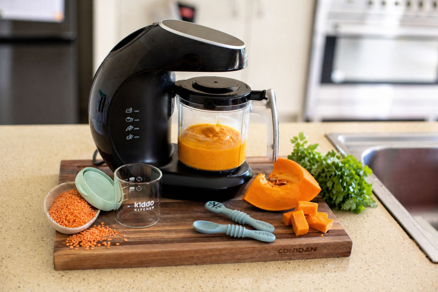 Lentil, pumpkin and coriander baby puree being blended with fresh ingredients on kitchen bench
